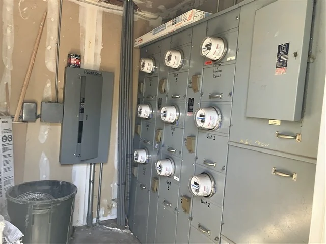 A tenant meter bank and house panel serving the units of a commercial building