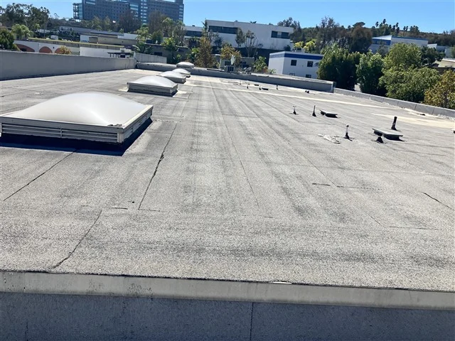 Skylights and drainage across the flat roof of a commercial building