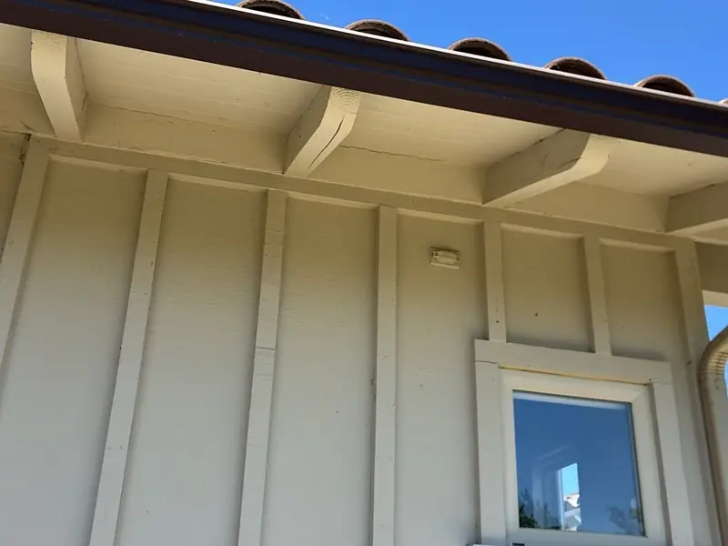 Stucco exterior, window head and eave