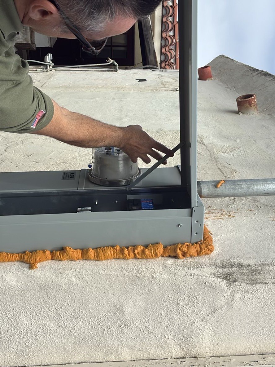 Inspector taking a measurement on a flat roof