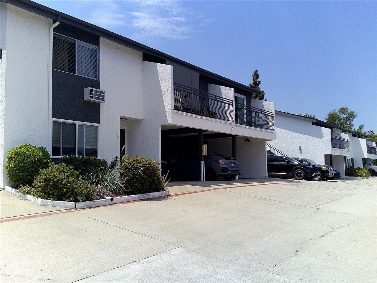 Modern condo building with iron balcony railings in Vista, CA
