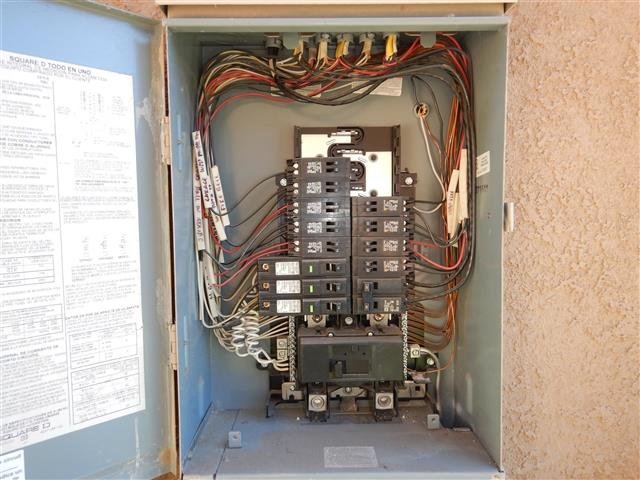 Open Square D electrical panel showing labeled circuit breakers in neat rows