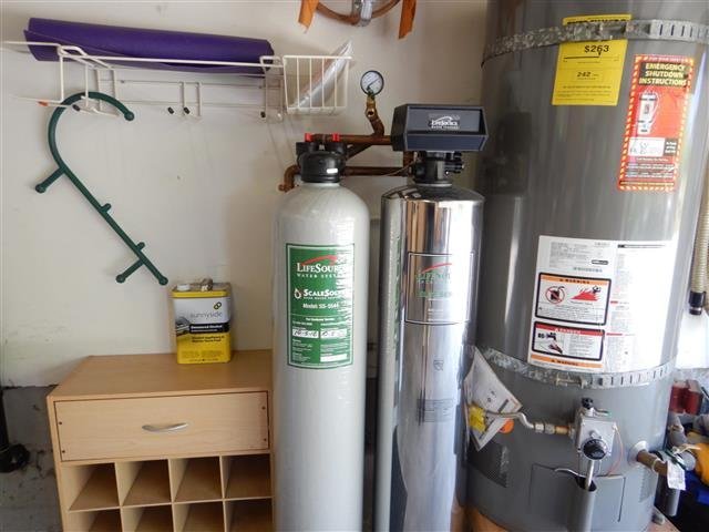 Gas water heater alongside LifeSource whole-house water softener and filtration tanks