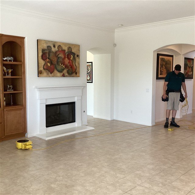 Inspector running a floor levelness measurement with a ZipLevel in a living room