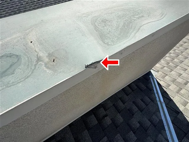 Roof parapet wall cap flashing evaluated during a San Diego commercial building inspection.