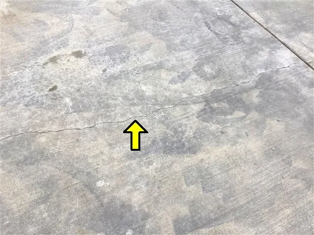 Concrete driveway settling crack documented during a San Diego pre-listing seller’s inspection.